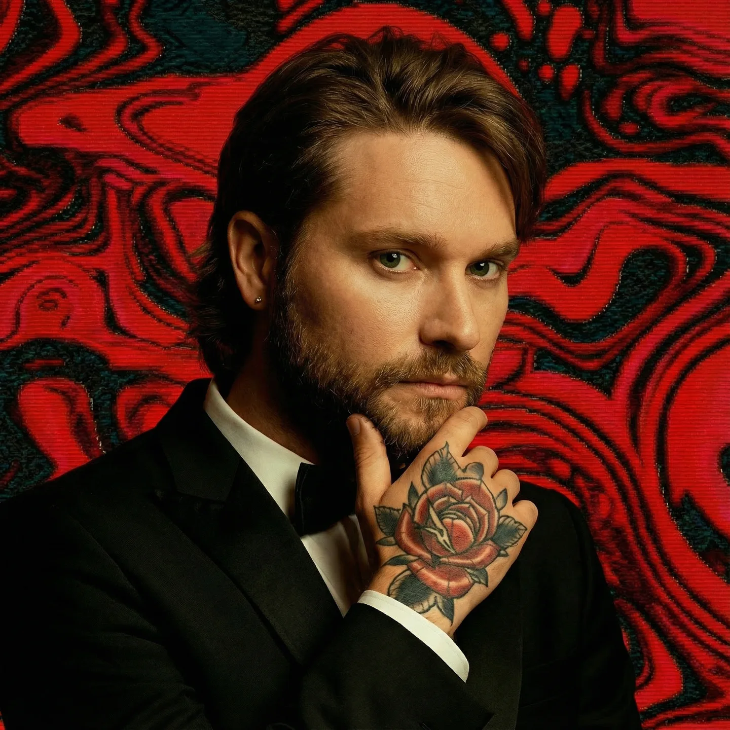 Creative portrait of Matt against red and black swirling artwork